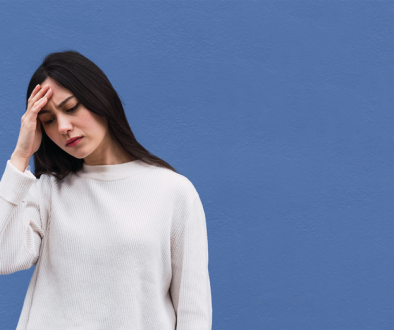 Woman with her hand on her head distresssed
