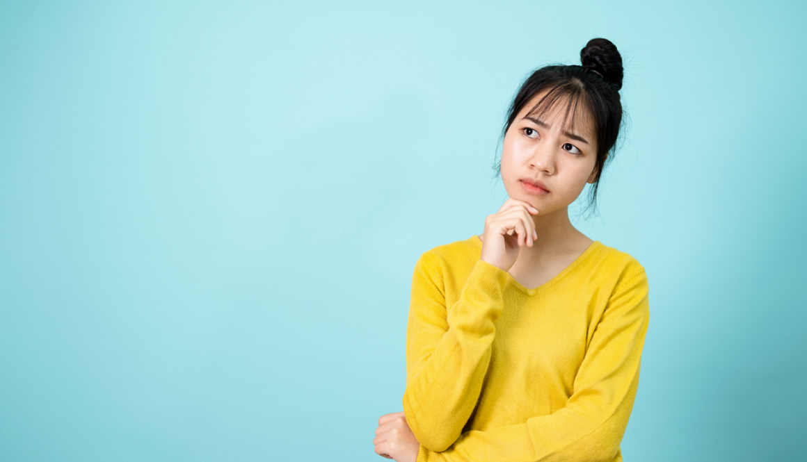 Woman thinking with her hand on her chin