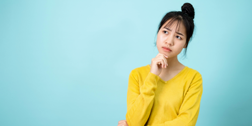 Woman thinking with her hand on her chin